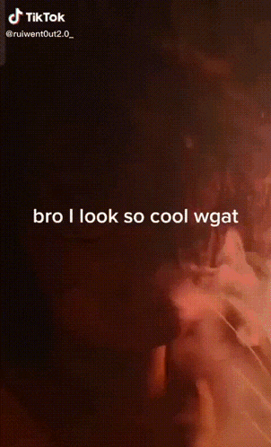 a tik tok video of a man smoking a cigarette with the caption bro i look so cool wgat