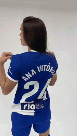 a woman wearing a blue jersey with ana vitoria on the back