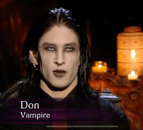 a picture of a vampire named don vampire with candles in the background