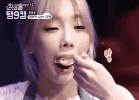 a close up of a woman eating something with the words snapfinger42 in the background
