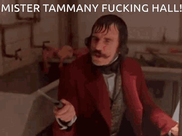 a man in a red suit with the words mister tammany fucking hall behind him