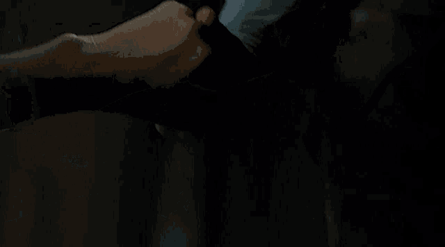 a close up of a person 's fist being punched in the dark