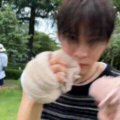 a person with a bandage on their arm is holding a white object in their hand .