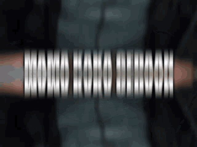 a close up of a metal object with a blurred background and a few lines