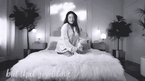 a black and white photo of a woman on a bed with the words but that good love
