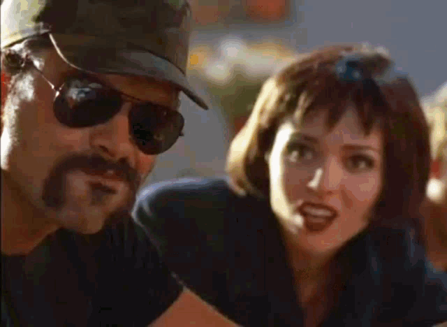 a man with a mustache is talking to a woman