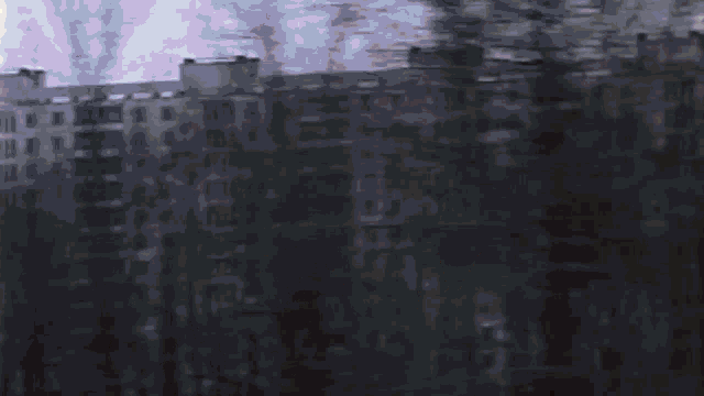 a blurry picture of a building with trees in the foreground