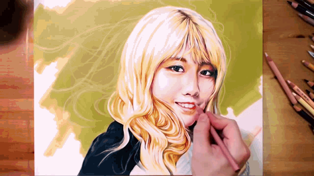 a drawing of a woman with blonde hair is being painted on a piece of paper