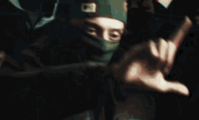 a group of people wearing hoods and masks with one wearing a hat with the letter d on it