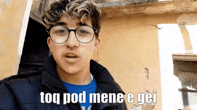 a man wearing glasses and a blue shirt says toq pod mene e gei