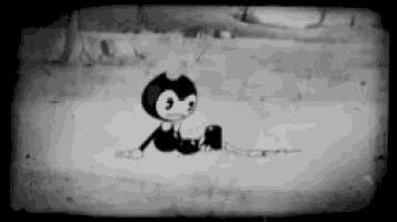 a cartoon character is sitting on the ground in a black and white photo .