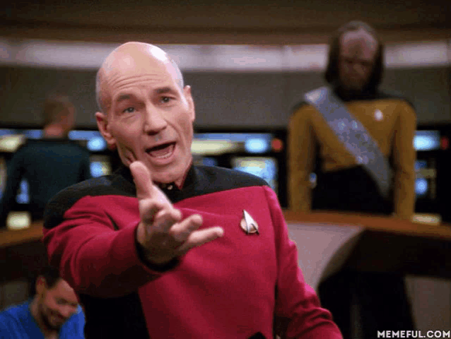 a man in a star trek uniform is pointing his finger at the camera