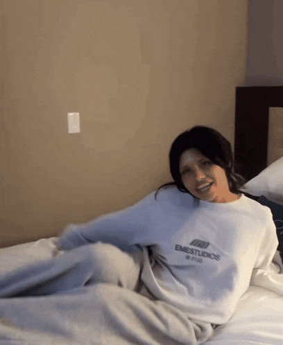 a woman wearing a sweatshirt that says emestudios