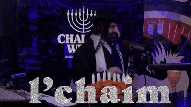 a man in a suit stands in front of a microphone in front of a chai world sign