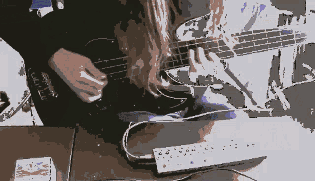 a pixelated image of a person playing a guitar with a cord plugged into it