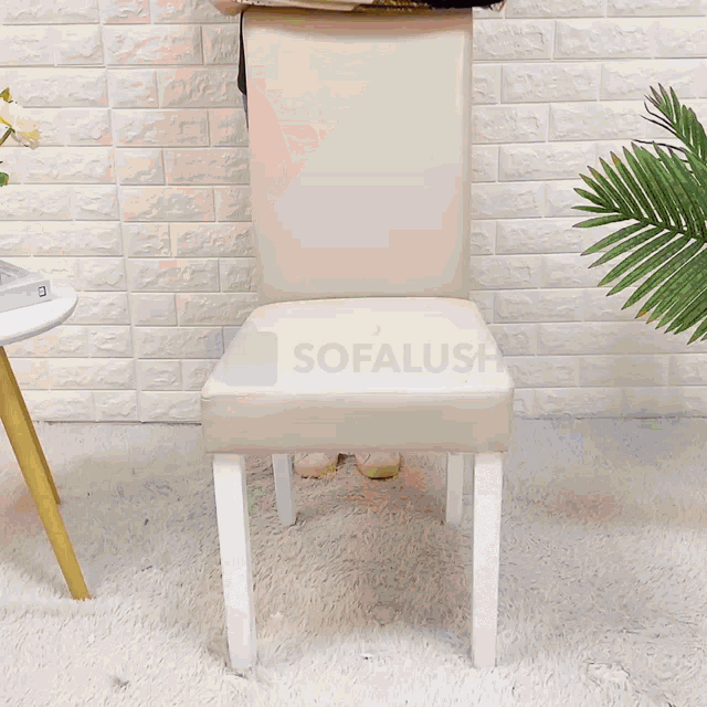 a woman is sitting on a chair holding a pillow that says sofalush on it