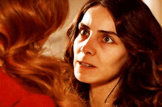 a close up of a woman looking at another woman