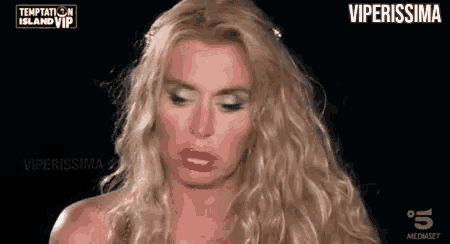 a woman with blonde hair and red lips is making a funny face on a black background .