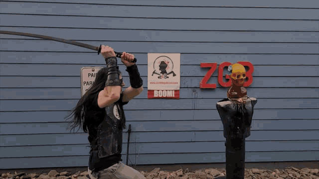 a man holding a sword in front of a sign that says " boom "
