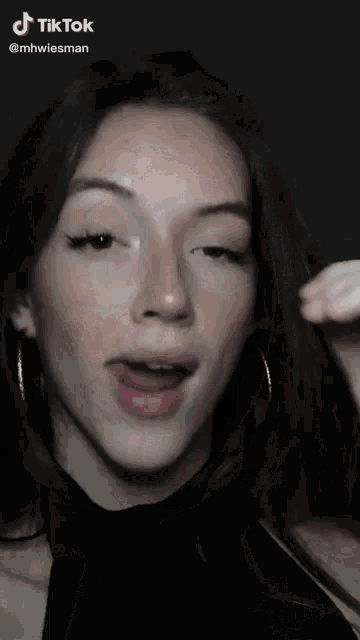 a woman 's face is shown in a tiktok video taken by mhwiesman