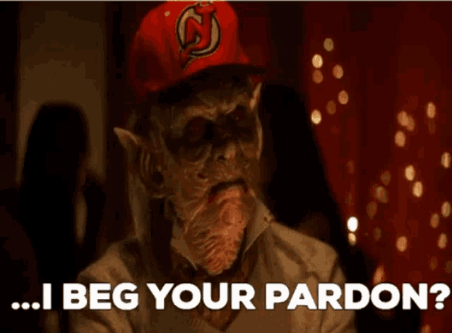 a monster wearing a red hat with the letter s on it says i beg your pardon