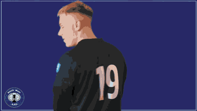 a man wearing a blue and black shirt with the word core37 on it