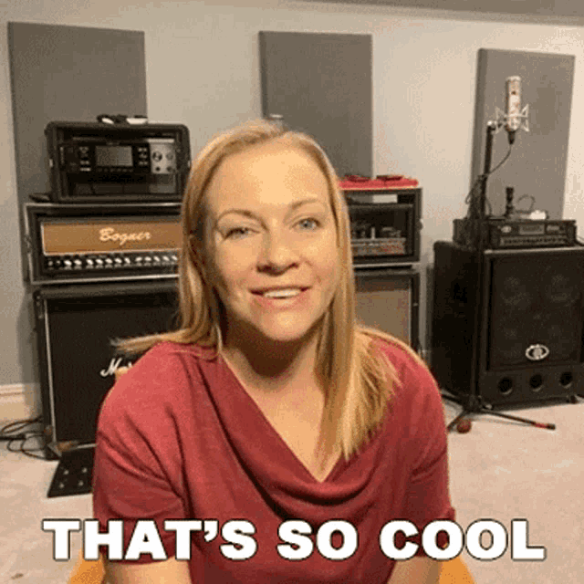 a woman says that 's so cool in front of a microphone