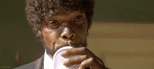 a close up of a man drinking from a cup with worm written on the bottom