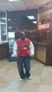 a man in a red jacket is dancing in front of a neon sign that says 200 dollars