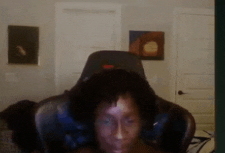 a man is sitting in a chair with headphones on a video call .