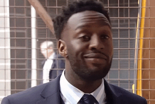 a man in a suit and tie is smiling