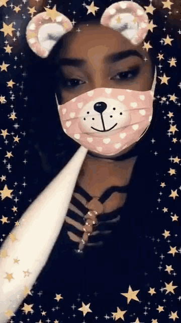 a girl wearing a teddy bear face mask with ears