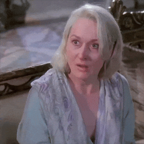 a woman with blonde hair is wearing a blue and purple shirt
