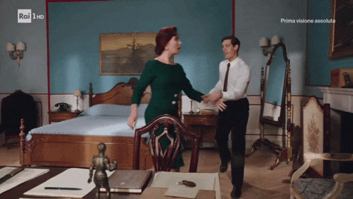 a man and woman are dancing in a room with rai 1 hd written on the bottom