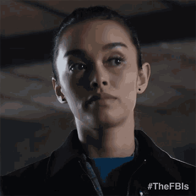 a woman in a black jacket with correct written on it