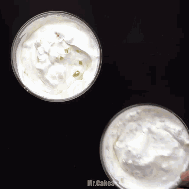 two bowls of whipped cream with mr.cakes written on the bottom right