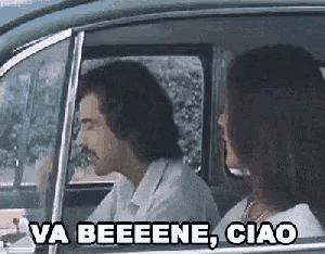 a man and a woman are sitting in a car with the words va beeeene , ciao written on the screen .