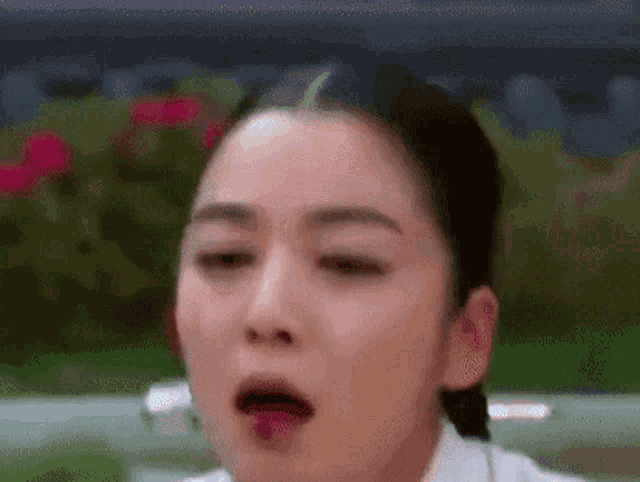 a close up of a woman making a funny face with her mouth open .