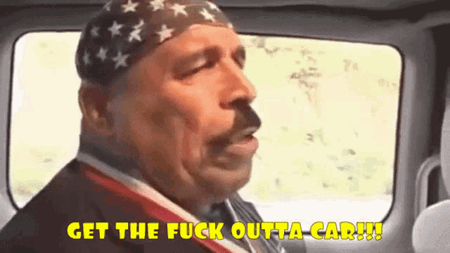a man with a bandana on his head says " get the fuck outta car "