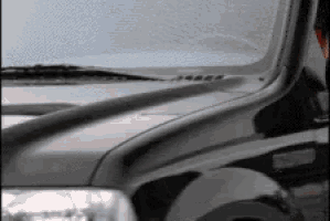 a black and white photo of a car with a hood scoop