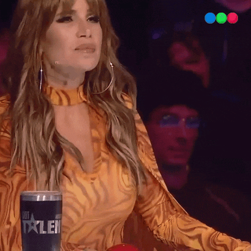 a woman is sitting in front of a can that says talent