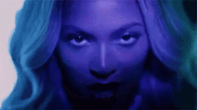 a close up of a woman 's face with a blue background