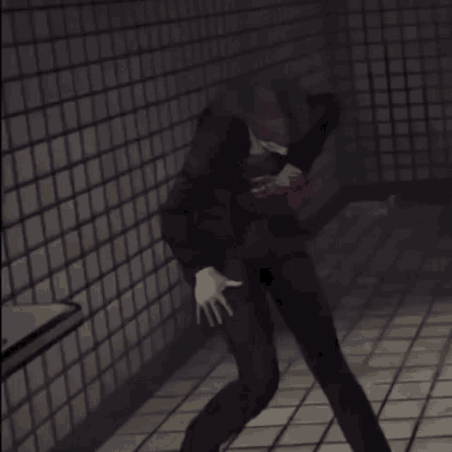 a man in a suit is standing in a dark room with blood coming out of his chest