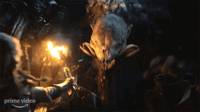 a person holding a torch in front of a monster with the word prime video on the bottom right