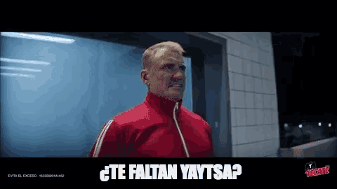 a man in a red jacket says te faltan yaytsap
