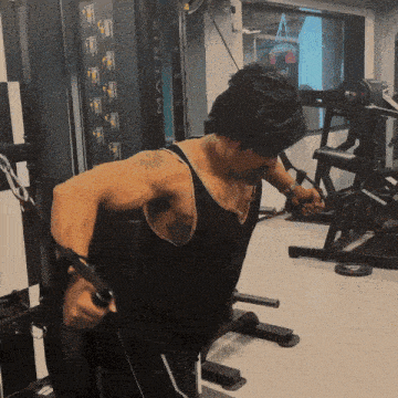 a man in a black tank top is using a machine that says matrix on it