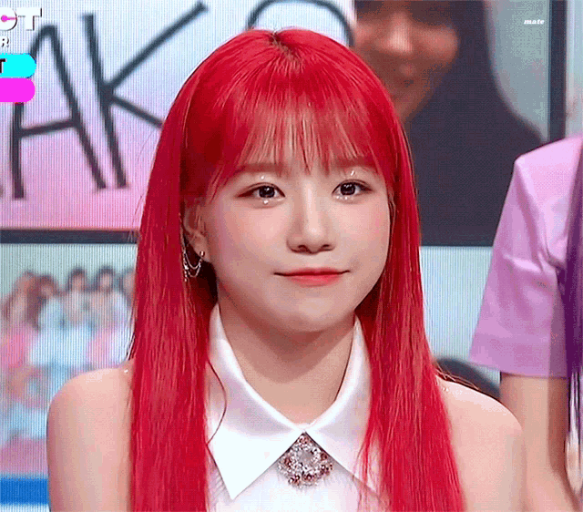 a girl with red hair is wearing a white collared shirt