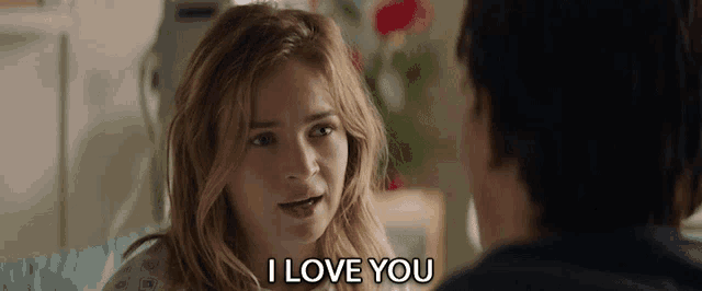 a woman in a hospital gown says i love you to a man in a hospital bed