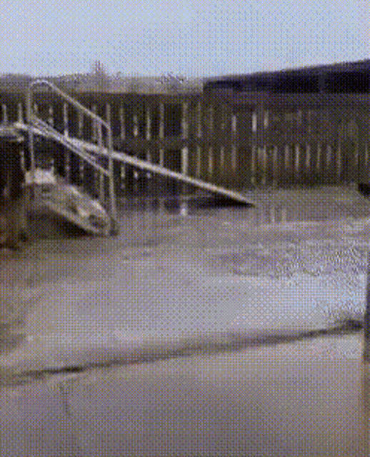 a skateboarder is doing a trick on a ramp in front of a building