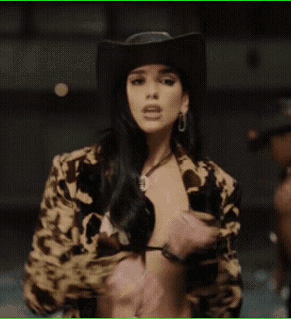 a woman wearing a cowboy hat and bikini top